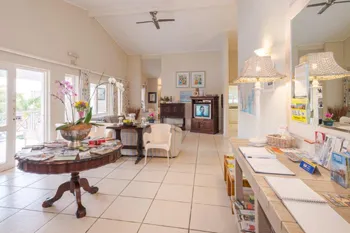 Bright lobby with seating area TV and reception desk with brochures