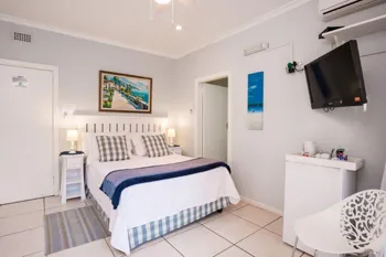 Bedroom with a double bed wallmounted TV and modern decor