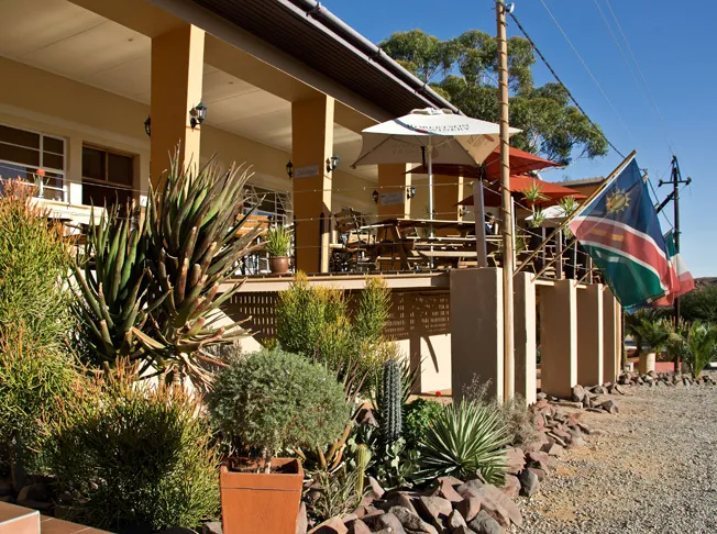 Outdoor patio with plants flag of Namibia and a building with columns