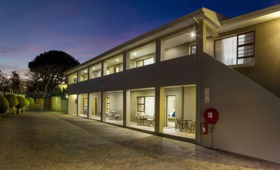 Modern building with illuminated rooms at night outdoor seating area