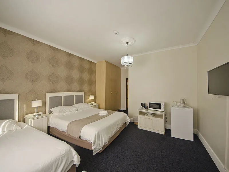 Hotel room with two beds TV and bedside tables