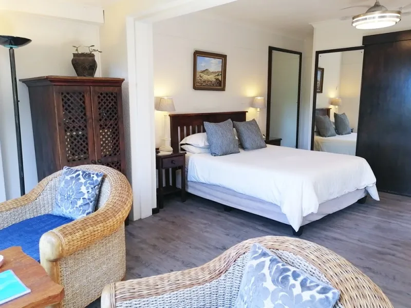 Cozy bedroom with a bed chair and wardrobe featuring blue and white decor
