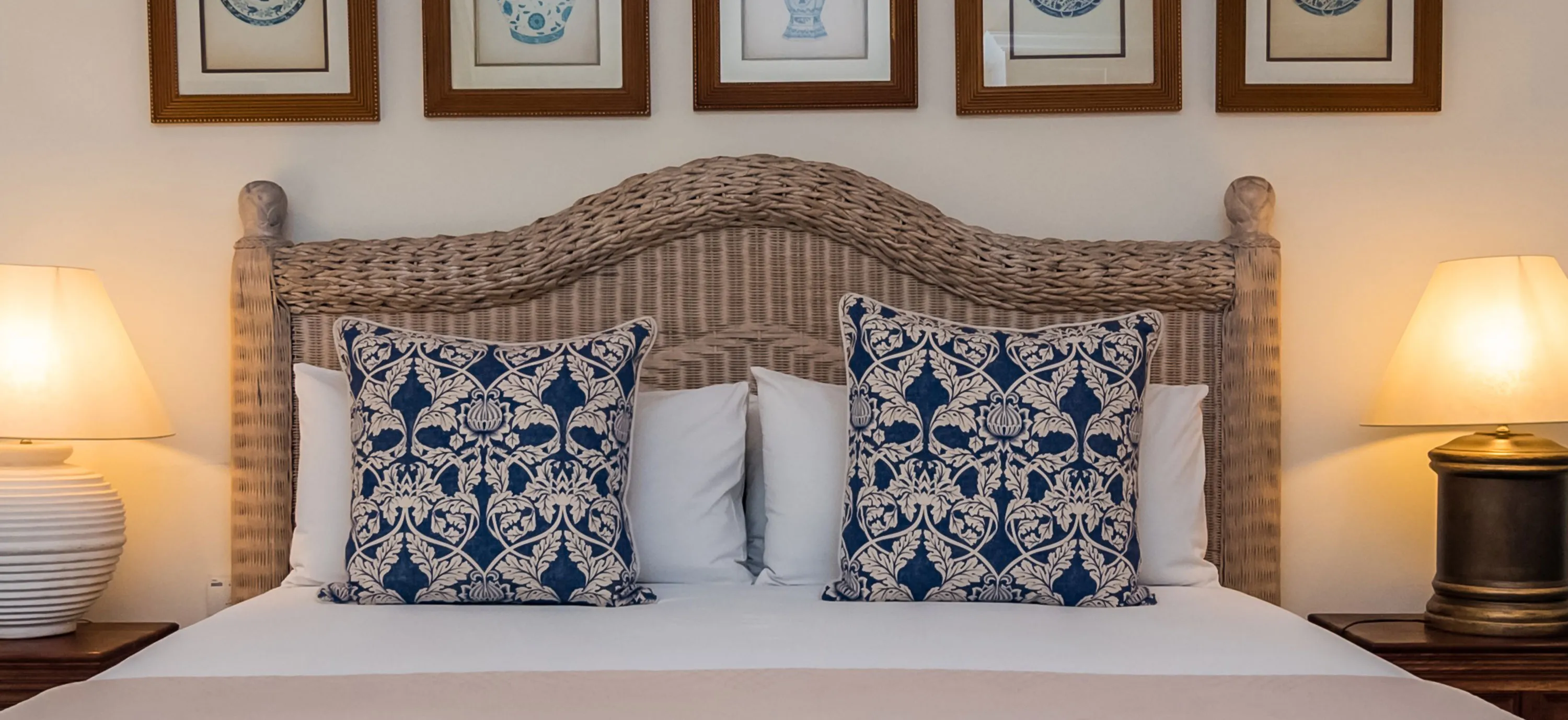 A neatly made bed with decorative pillows and bedside lamps in a bedroom