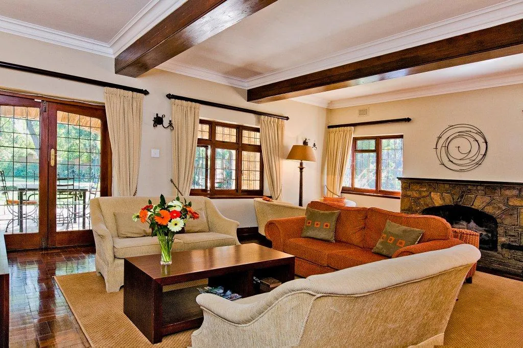 Cozy living room with fireplace sofas wooden beams and large windows