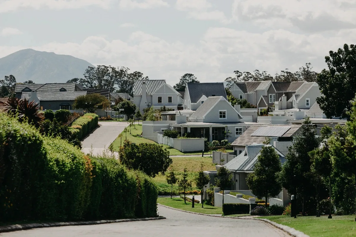Suburban neighborhood with modern houses greenery and mountains in the background