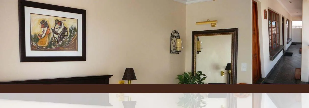 Bedroom with artwork mirror lamp and hallway view