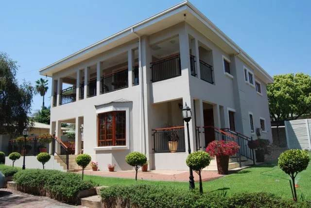 Modern twostory house with a balcony garden and decorative plants