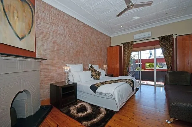Bedroom with large bed fireplace and sliding door to patio