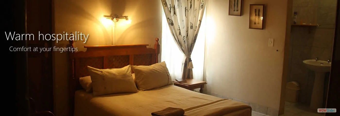 Cozy bedroom with a bed lamp window and adjacent bathroom