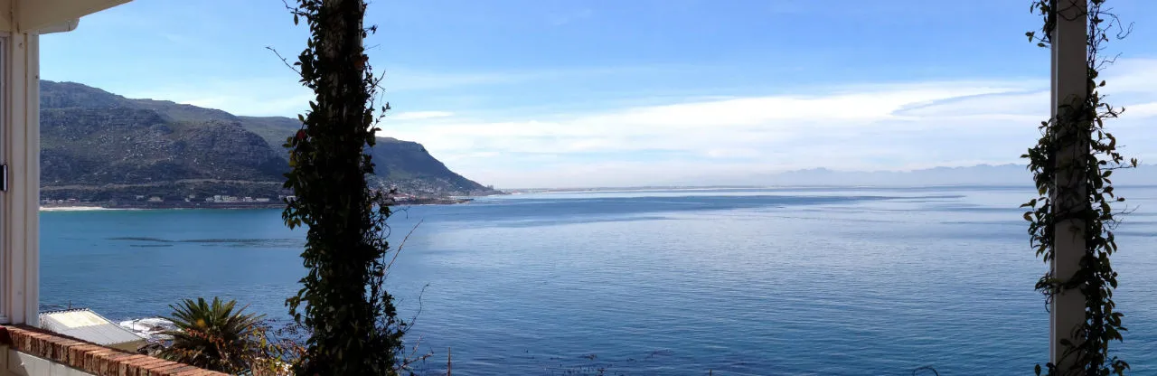 Ocean view from a balcony with mountains in the background