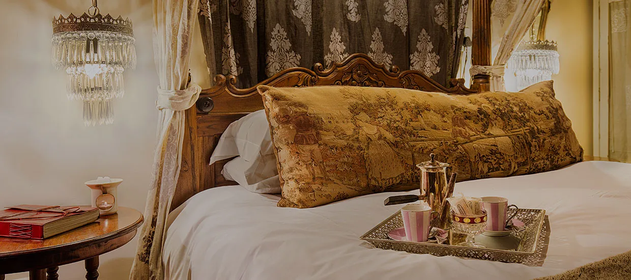 Ornate bedroom with a large bed pillows and a breakfast tray