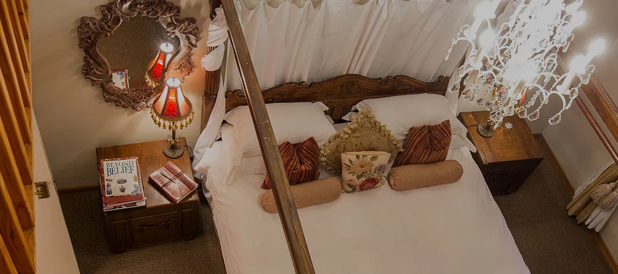 Cozy bedroom with a large bed pillows and bedside tables with lamps