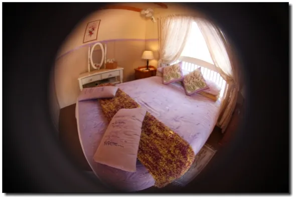 Cozy bedroom with a large bed pillows and a vanity table