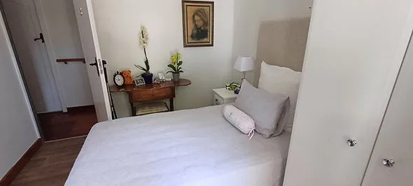 Cozy bedroom with bed nightstand and a painting on the wall