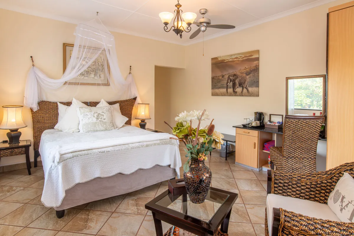 Cozy bedroom with a large bed wicker furniture and a ceiling fan