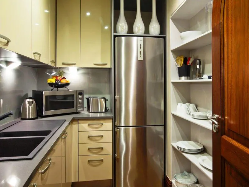 Modern kitchen with stainless steel appliances wooden cabinets and white shelves