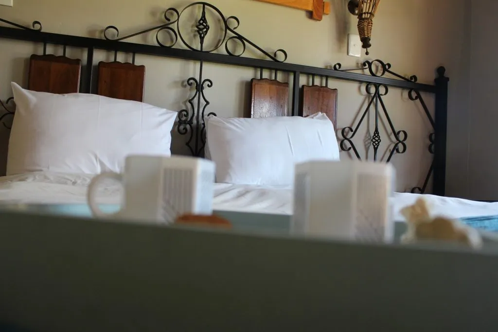 Bed with decorative metal headboard and pillows in a cozy room