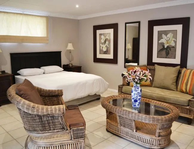 Bedroom with bed wicker furniture and floral decor in a cozy setting