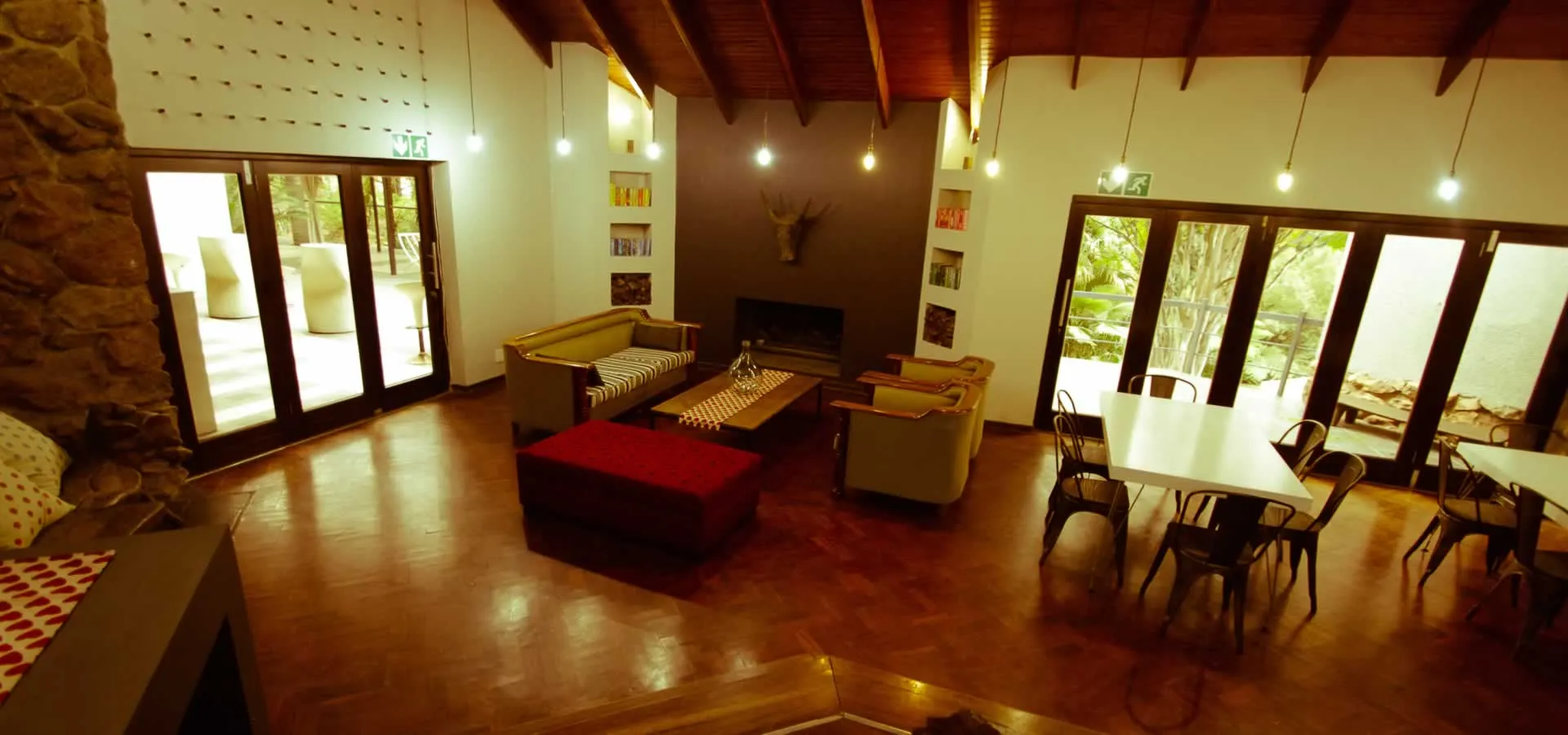 Cozy living room with fireplace sofas and dining area large windows