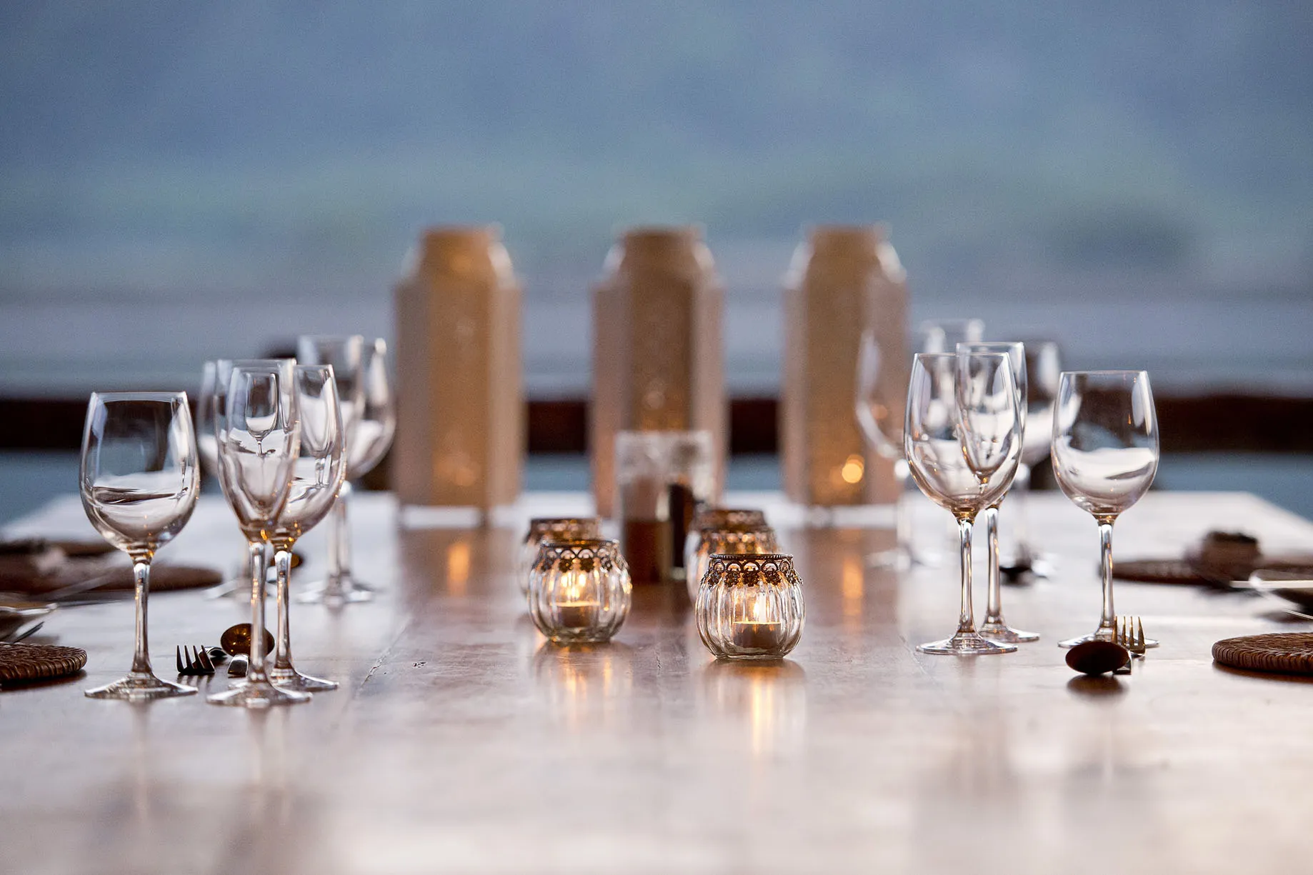 Elegant table setting with wine glasses candles and blurred background