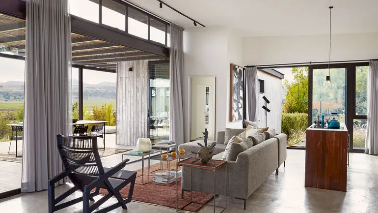 Modern living room with open view large windows and outdoor seating area