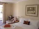 Cozy bedroom with a bed armchair and framed picture on the wall